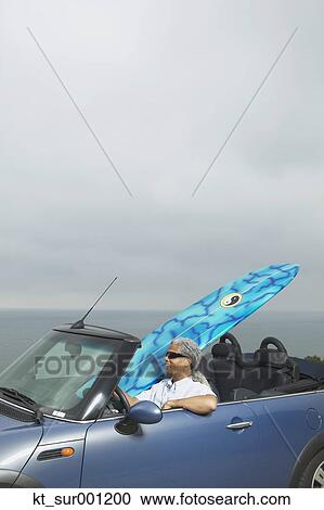 Senior man driving a convertible with a surfboard in it, Oakland, California, United States View Large Photo Image Stock Image - Senior man driving a convertible with a surfboard in it, Oakland, California, United States. Fotosearch
