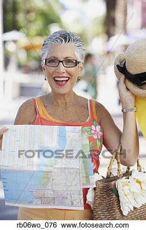 Senior woman holding a map, Miami, Florida, United States View Large Photo Image Stock Photograph - Senior woman holding a map, Miami, Florida, United States. Fotosearch