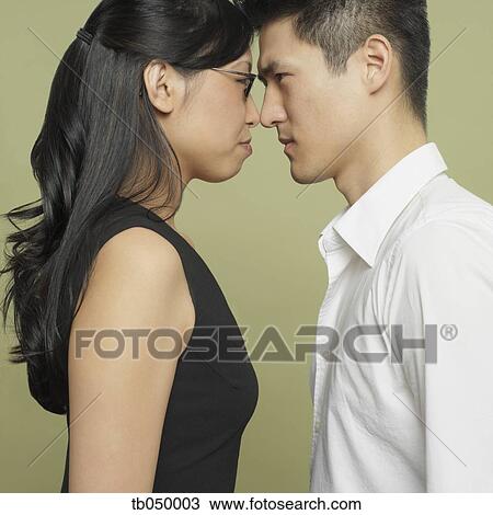 Studio shot of Asian couple head to head View Large Photo Image Stock Image - Studio shot of Asian couple head to head. Fotosearch