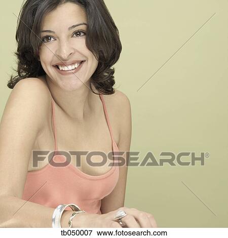 Stock Photo - Studio shot of young Hispanic woman smiling. Fotosearch