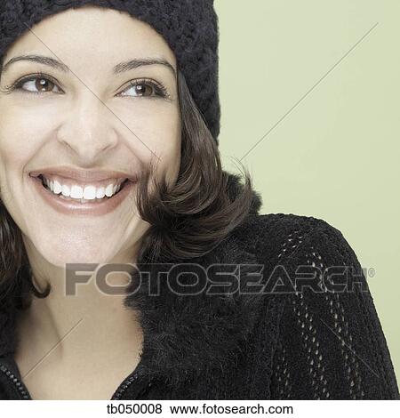 Stock Photo - Studio shot of young Hispanic woman smiling. Fotosearch