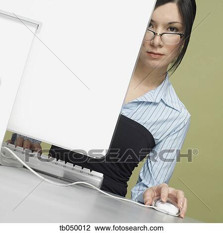 Studio shot of young woman with computer View Large Photo Image Stock Image - Studio shot of young woman with computer. Fotosearch