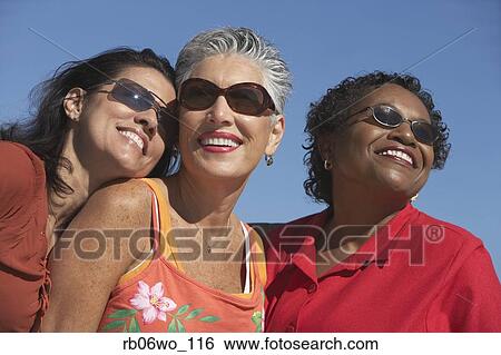 Three middle-aged women smiling, Miami, Florida, United States View Large Photo Image Stock Photograph - Three middle-aged women smiling, Miami, Florida, United States. Fotosearch