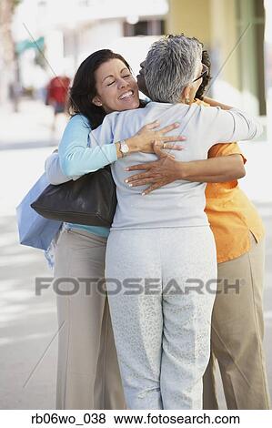 Three women hugging outdoors, Miami, Florida, United States View Large Photo Image Stock Photo - Three women hugging outdoors, Miami, Florida, United States. Fotosearch