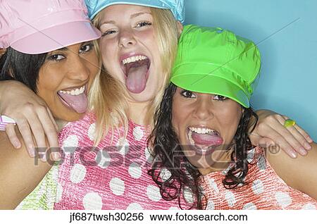 Three young women laughing and sticking their tongues out View Large Photo Image Stock Photograph - Three young women laughing and sticking their tongues out. Fotosearch