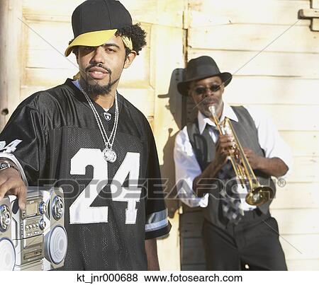 Young African man with boom box next to senior African man with trumpet, Oakland, California, United States View Large Photo Image Stock Photo - Young African man with boom box next to senior African man with trumpet, Oakland, California, United States. Fotosearch