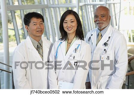 Stock Image - Young female Asian doctor with two middle-aged male doctors, North Bethesda, Maryland, United States. Fotosearch