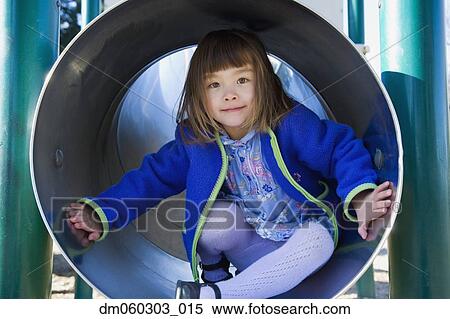 Young girl in play structure tube, Seattle, Washington, United States View Large Photo Image Stock Photography - Young girl in play structure tube, Seattle, Washington, United States. Fotosearch