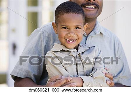 African American boy sitting on father's lap View Large Photo Image Stock Photograph - African American boy sitting on father's lap. Fotosearch