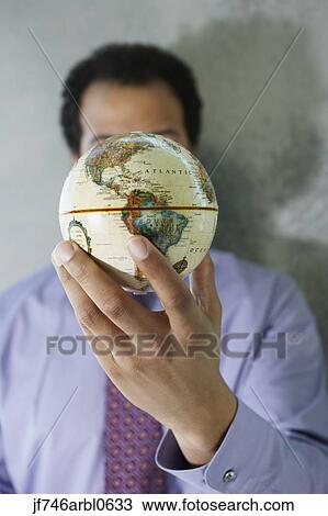 African American businessman holding globe in front of face View Large Photo Image Stock Image - African American businessman holding globe in front of face. Fotosearch