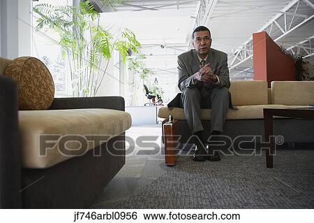 African American businessman sitting in waiting area View Large Photo Image Stock Photograph - African American businessman sitting in waiting area. Fotosearch