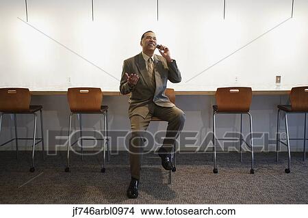 African American businessman talking on cell phone View Large Photo Image Picture - African American businessman talking on cell phone. Fotosearch