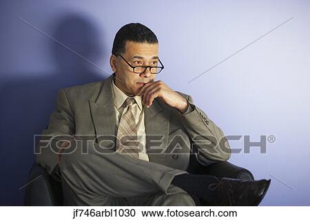 Stock Image - African American businessman wearing glasses. Fotosearch