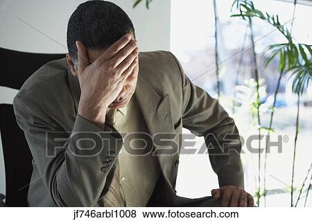 African American businessman with hand over face View Large Photo Image Stock Photo - African American businessman with hand over face. Fotosearch