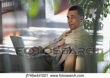 Stock Image - African American businessman with laptop. Fotosearch