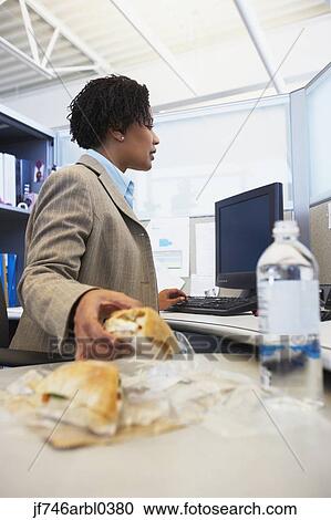 African American businesswoman eating lunch at desk View Large Photo Image Stock Image - African American businesswoman eating lunch at desk. Fotosearch