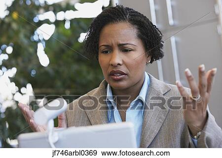 Stock Photo - African American businesswoman with laptop. Fotosearch