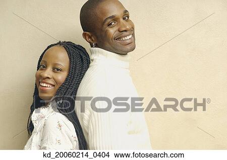 African American couple standing back to back smiling View Large Photo Image Picture - African American couple standing back to back smiling. Fotosearch