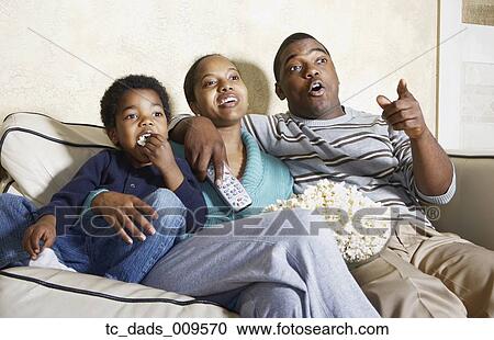 African American family watching television with popcorn View Large Photo Image Stock Image - African American family watching television with popcorn . Fotosearch