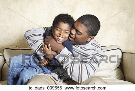 African American father and young son playing on sofa View Large Photo Image Stock Photography - African American father and young son playing on sofa. Fotosearch