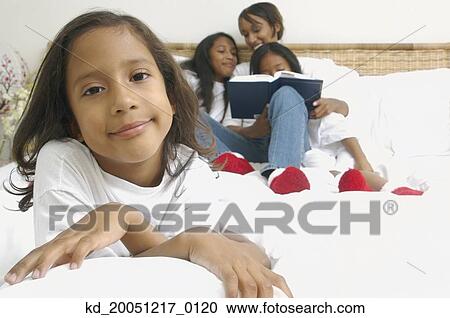 African American girl on bed with family behind her View Large Photo Image Stock Image - African American girl on bed with family behind her. Fotosearch