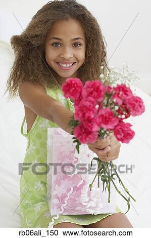 Stock Image - African American girl with bouquet of flowers. Fotosearch