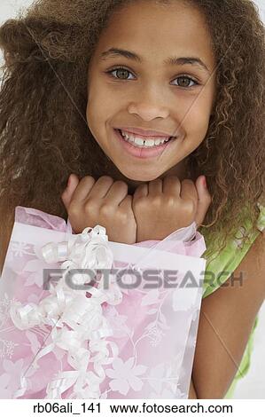 African American girl with gift bag View Large Photo Image Stock Image - African American girl with gift bag. Fotosearch
