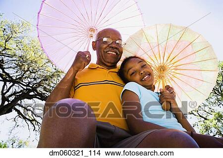 African American grandfather and granddaughter with parasols View Large Photo Image Picture - African American grandfather and granddaughter with parasols. Fotosearch