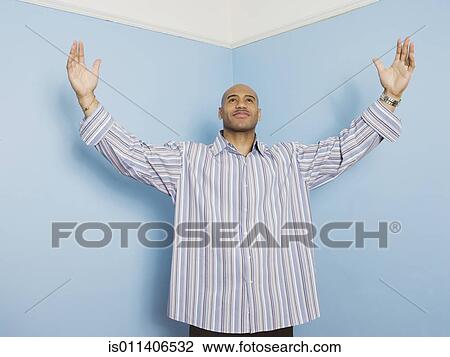 Stock Image - African American man with arms raised. Fotosearch