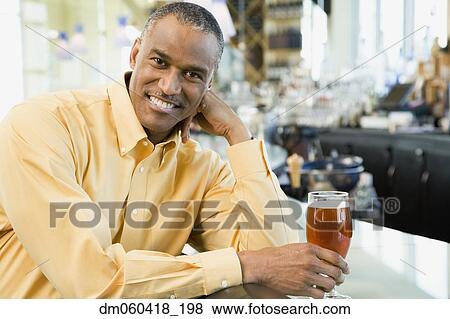 African American man with drink at bar View Large Photo Image Stock Photo - African American man with drink at bar. Fotosearch
