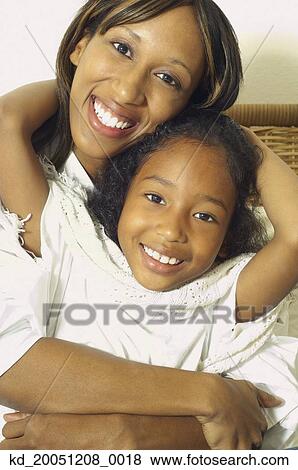 Stock Photo - African American mother and daughter hugging. Fotosearch