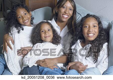 Stock Photograph - African American mother with daughters smiling. Fotosearch
