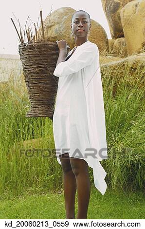 African American woman carrying basket outdoors View Large Photo Image Stock Photo - African American woman carrying basket outdoors. Fotosearch