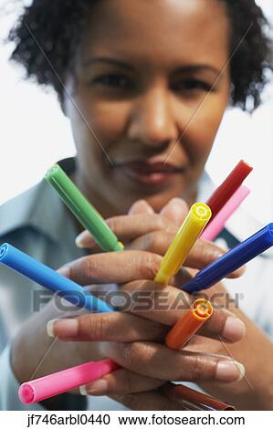 African American woman holding multicolored markers in hands View Large Photo Image Stock Image - African American woman holding multicolored markers in hands. Fotosearch