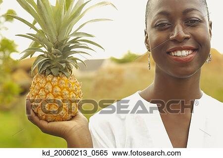 African American woman holding pineapple outdoors View Large Photo Image Stock Photography - African American woman holding pineapple outdoors. Fotosearch
