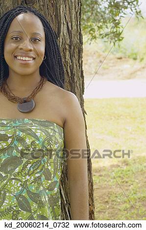African American woman leaning on tree View Large Photo Image Stock Image - African American woman leaning on tree. Fotosearch