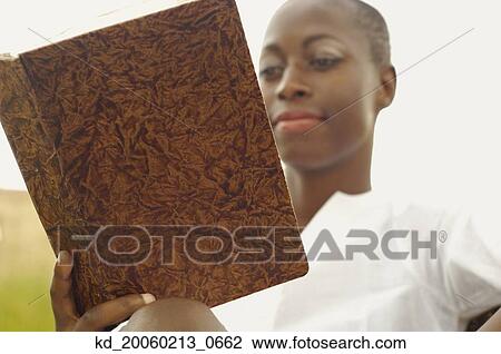 African American woman reading book outdoors View Large Photo Image Stock Image - African American woman reading book outdoors. Fotosearch