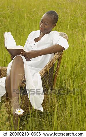 African American woman reading book outdoors View Large Photo Image Stock Photograph - African American woman reading book outdoors. Fotosearch