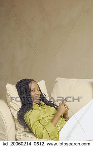 African American woman with MP3 player on sofa View Large Photo Image Stock Image - African American woman with MP3 player on sofa. Fotosearch