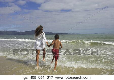 African mother and son running in the surf, Florianopolis, Brazil View Large Photo Image Stock Photo - African mother and son running in the surf, Florianopolis, Brazil. Fotosearch