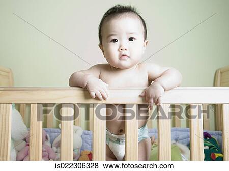 Asian Baby Standing In Crib Stock Photo Is022306328 Fotosearch