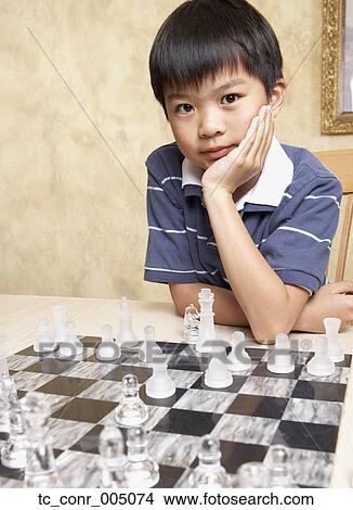 Asian boy playing chess View Large Photo Image Picture - Asian boy playing chess . Fotosearch
