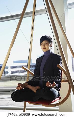 Asian businesswoman meditating View Large Photo Image Stock Photo - Asian businesswoman meditating. Fotosearch