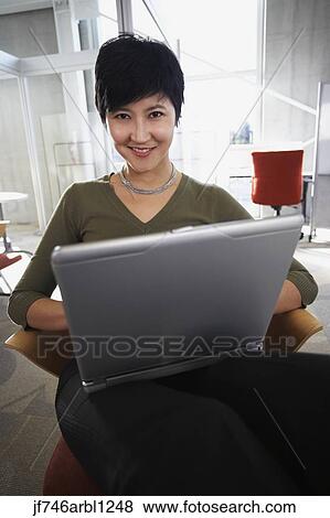 Asian businesswoman with laptop View Large Photo Image Stock Photo - Asian businesswoman with laptop. Fotosearch