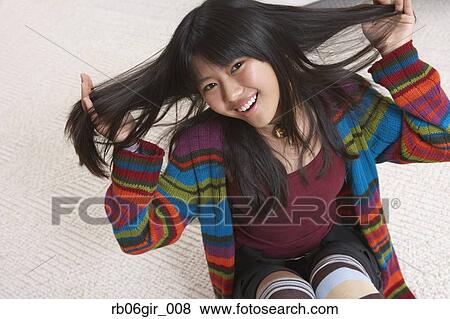Asian girl with hands in hair View Large Photo Image Stock Photo - Asian girl with hands in hair. Fotosearch
