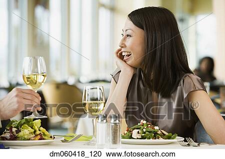 Asian woman laughing at restaurant View Large Photo Image Stock Image - Asian woman laughing at restaurant. Fotosearch