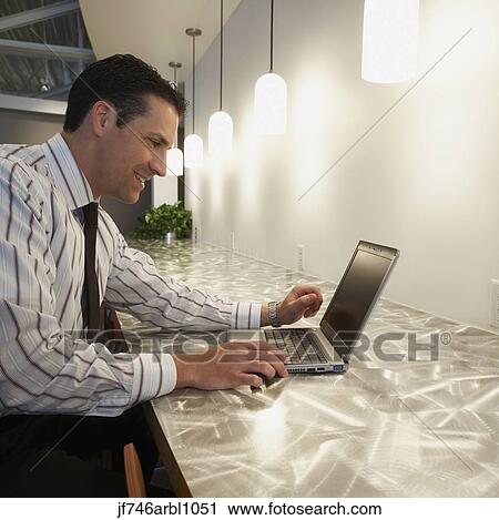Businessman using laptop View Large Photo Image Stock Image - Businessman using laptop. Fotosearch