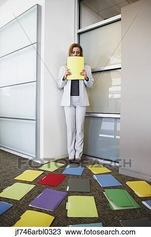 Businesswoman backed into corner by file folders View Large Photo Image Stock Image - Businesswoman backed into corner by file folders. Fotosearch