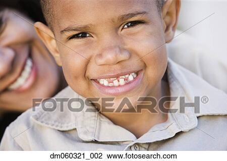 Stock Image - Close up of African American boy with mother. Fotosearch