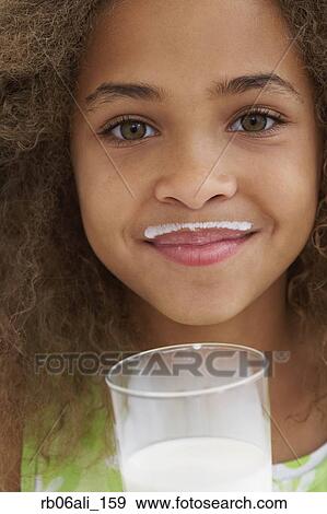 Stock Photo - Close up of African American girl with milk mustache. Fotosearch
